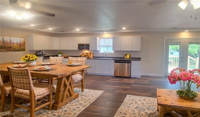 kitchen with french doors, sink, dark wood-type flooring, stainless steel appliances, and white cabinets