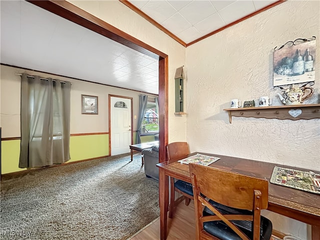 carpeted dining space with ornamental molding