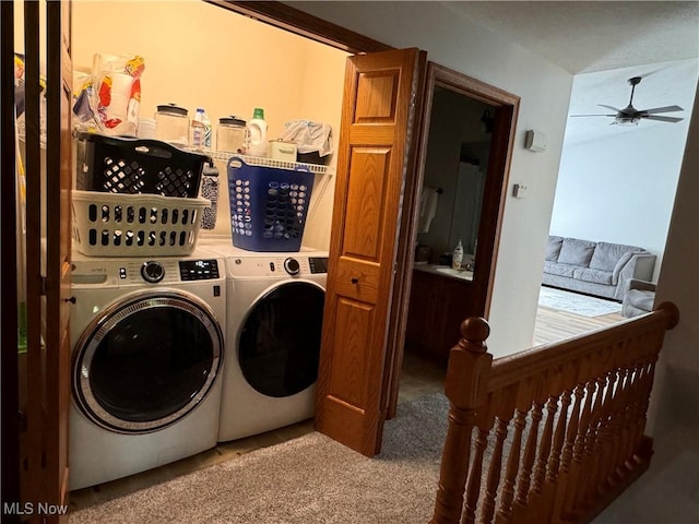 laundry room with ceiling fan, washer and clothes dryer, and light colored carpet