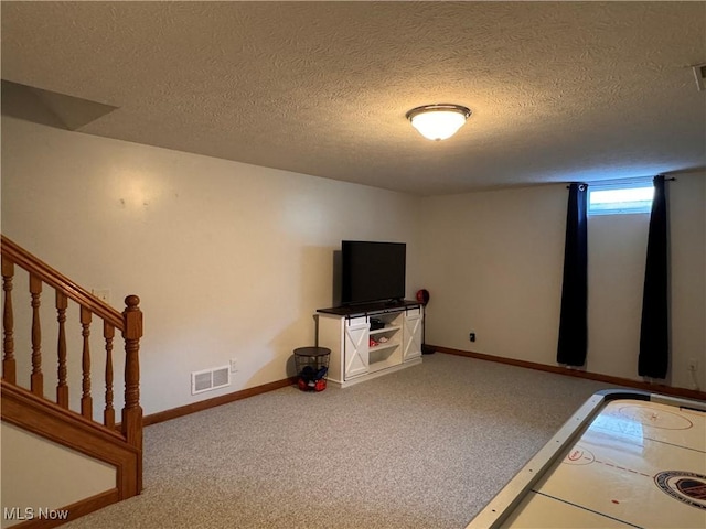 interior space with carpet flooring and a textured ceiling