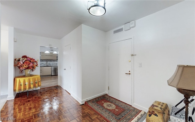 foyer entrance with dark parquet floors