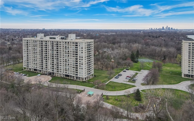 bird's eye view featuring a city view and a wooded view