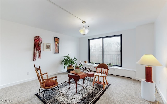 carpeted dining space with baseboards