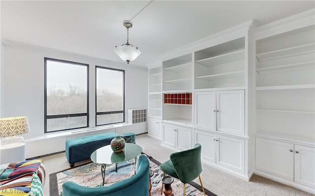 interior space with built in shelves, crown molding, and light colored carpet