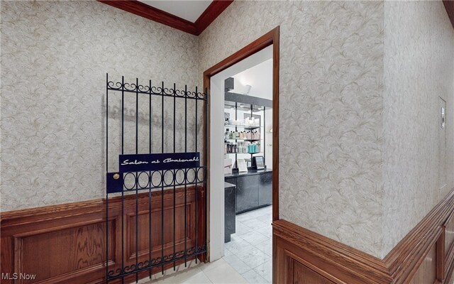hall featuring crown molding and wallpapered walls