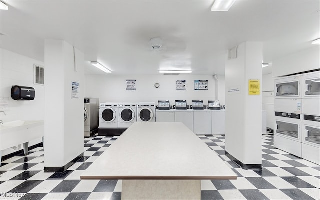 common laundry area featuring stacked washing maching and dryer, tile patterned floors, independent washer and dryer, and visible vents