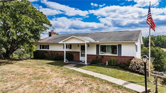 780 Mcgill Rd, Vincent, OH 45784 - view of front of house with brick siding, a chimney, and a front lawn