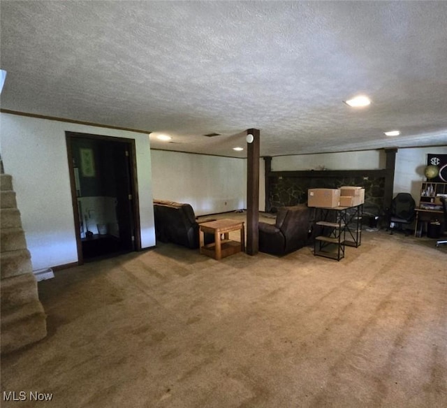 living room featuring carpet and a textured ceiling