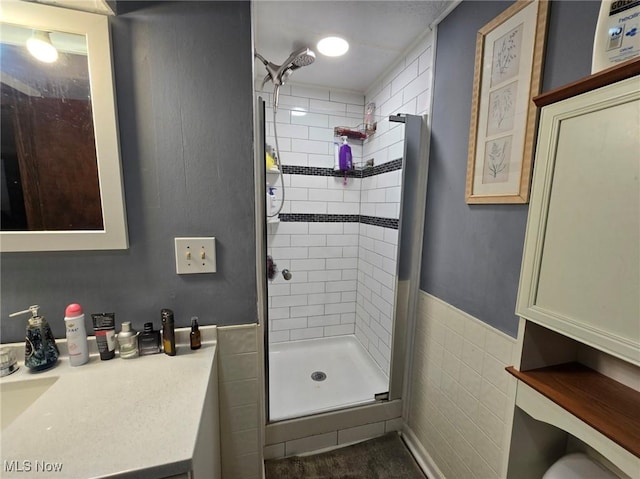 780 Mcgill Rd, Vincent, OH 45784 - bathroom with wainscoting, tile walls, a shower stall, and vanity