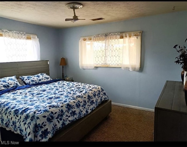 780 Mcgill Rd, Vincent, OH 45784 - bedroom with a textured ceiling, ceiling fan, visible vents, baseboards, and carpet