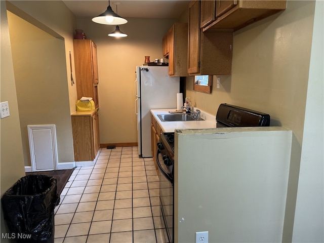 kitchen with light tile patterned floors, sink, and decorative light fixtures