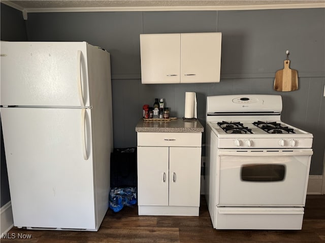 kitchen with white appliances, dark hardwood / wood-style floors, white cabinets, and crown molding