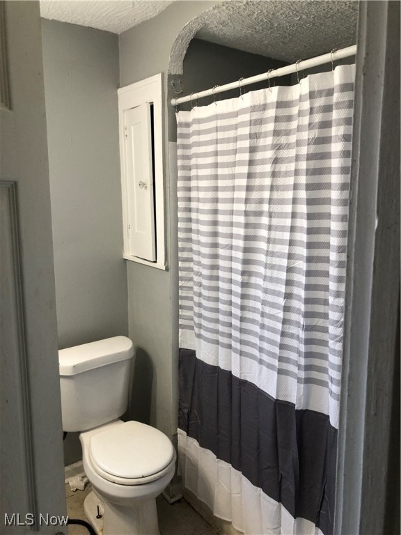 bathroom with a textured ceiling and toilet