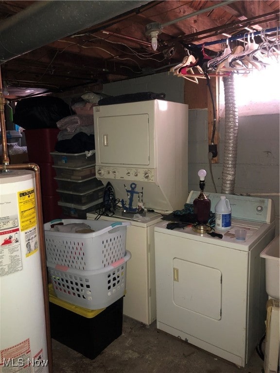 clothes washing area featuring stacked washer and clothes dryer and gas water heater