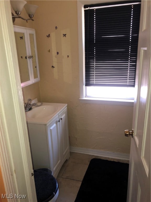 bathroom featuring vanity, toilet, and tile patterned flooring