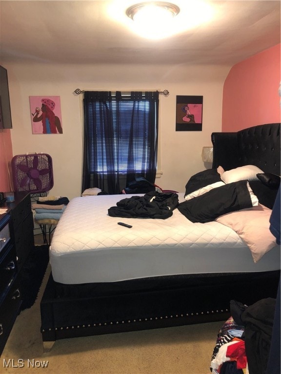 bedroom featuring vaulted ceiling and carpet