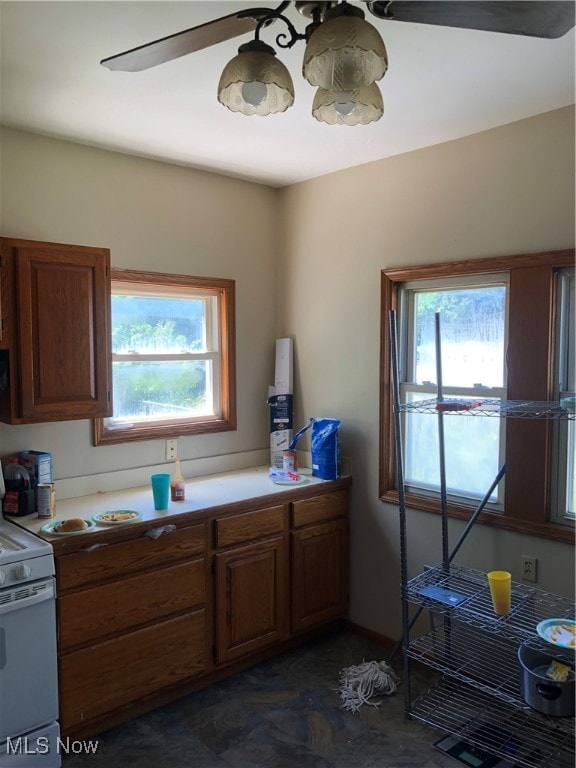 kitchen featuring white range with electric cooktop and ceiling fan