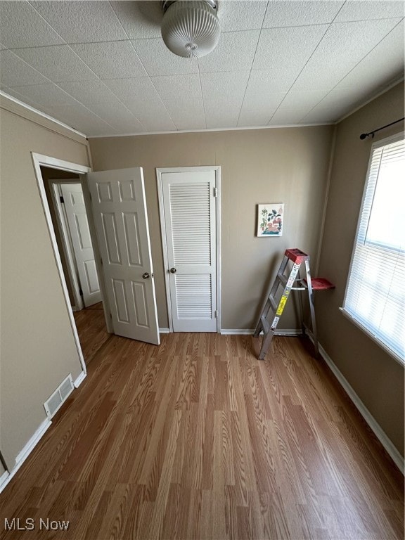 unfurnished bedroom with hardwood / wood-style floors