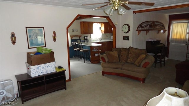 living room featuring ceiling fan and light colored carpet