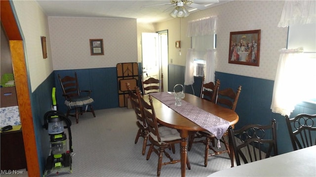 dining room with ceiling fan and carpet