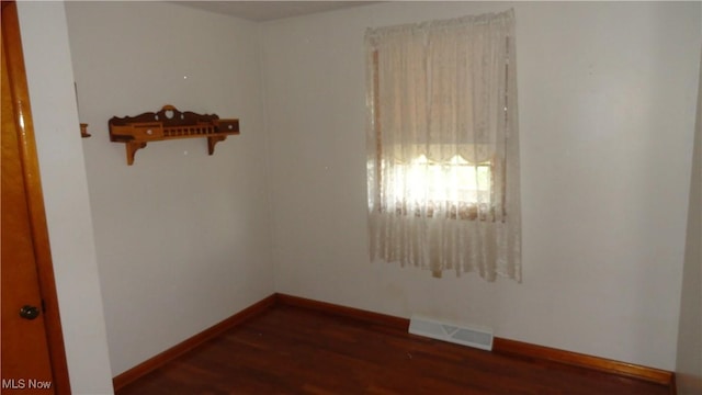 empty room featuring dark hardwood / wood-style flooring