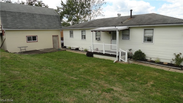 rear view of house featuring a yard