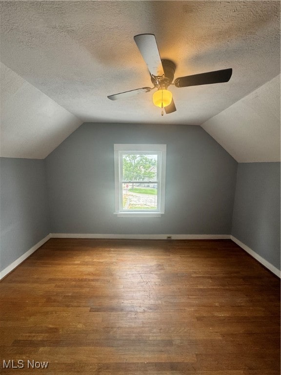 bonus room with lofted ceiling, wood-type flooring, a textured ceiling, and ceiling fan