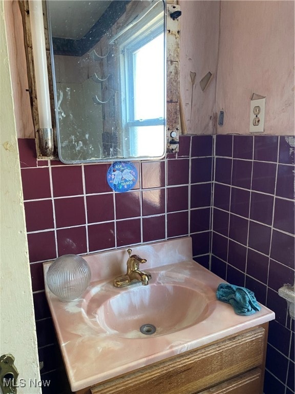 bathroom with tile walls and vanity