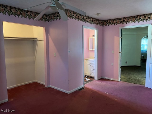 unfurnished bedroom with connected bathroom, carpet, a closet, and ceiling fan