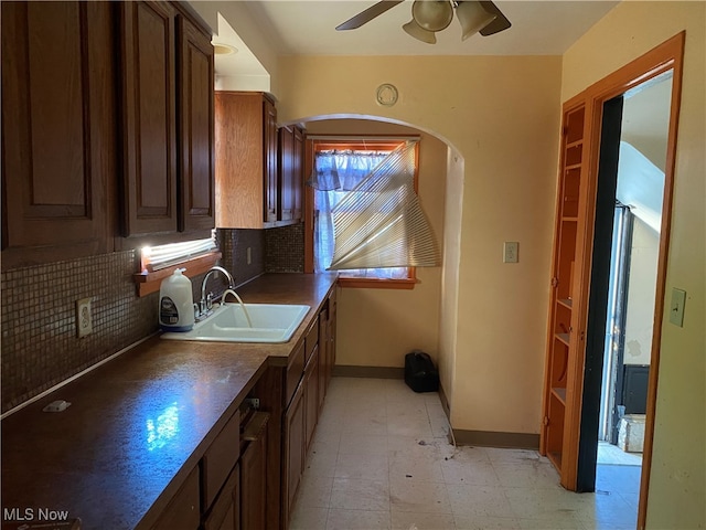 kitchen featuring ceiling fan, sink, and decorative backsplash