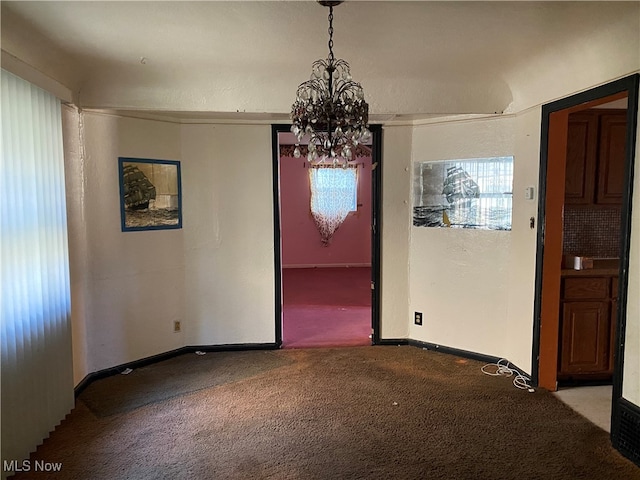 unfurnished dining area featuring carpet flooring and a chandelier