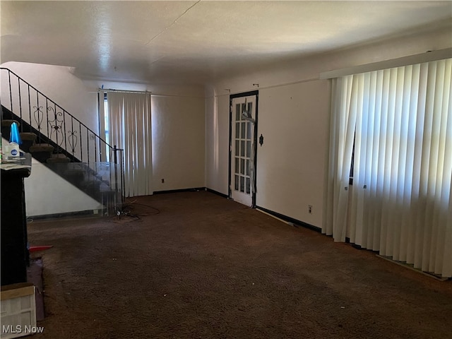 unfurnished living room featuring carpet