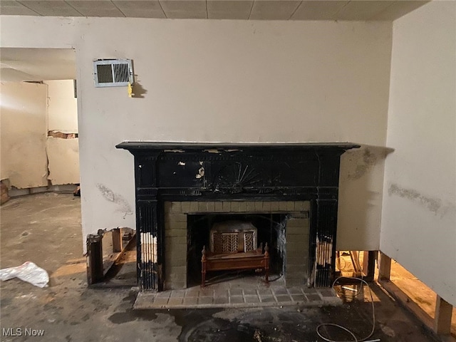 interior details featuring a brick fireplace