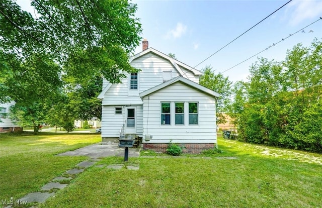 rear view of house with a lawn