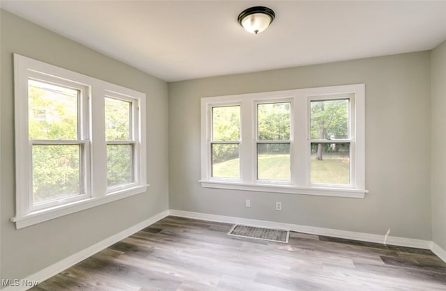 unfurnished room featuring hardwood / wood-style flooring