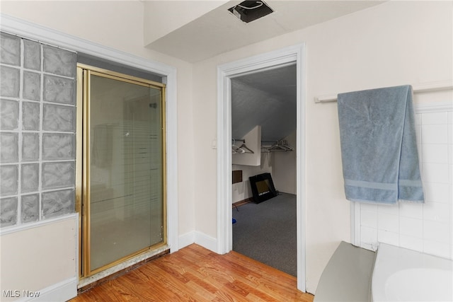 bathroom featuring an enclosed shower and hardwood / wood-style floors