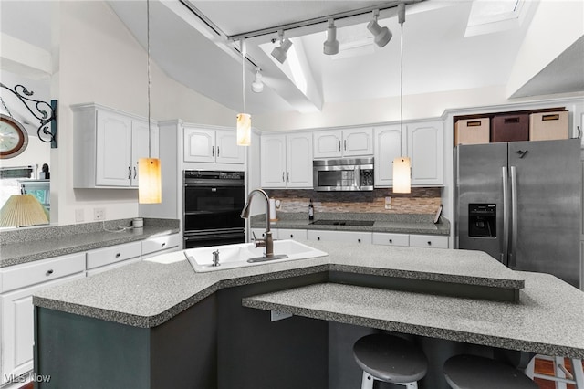 kitchen with sink, tasteful backsplash, black appliances, a center island with sink, and white cabinets