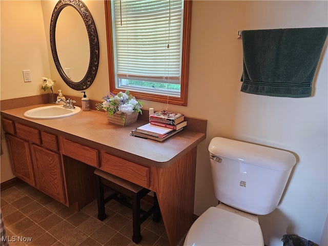 bathroom featuring vanity and toilet