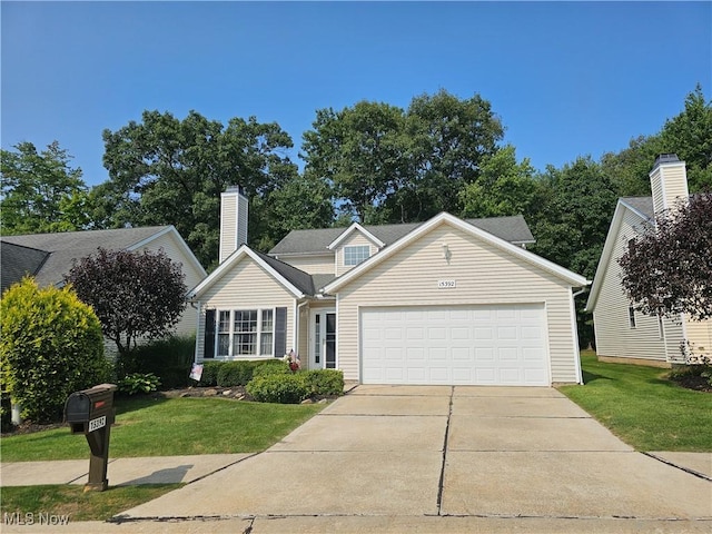 view of front of property featuring a garage and a front yard