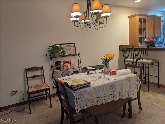 carpeted dining room featuring a chandelier