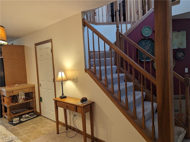 staircase featuring tile patterned floors