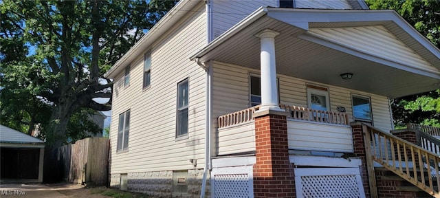 view of side of property with covered porch