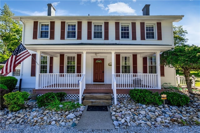 colonial inspired home featuring a porch