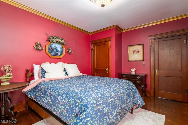 bedroom with dark hardwood / wood-style floors and ornamental molding