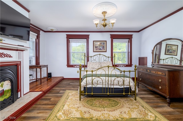 bedroom with dark hardwood / wood-style flooring, a chandelier, and crown molding