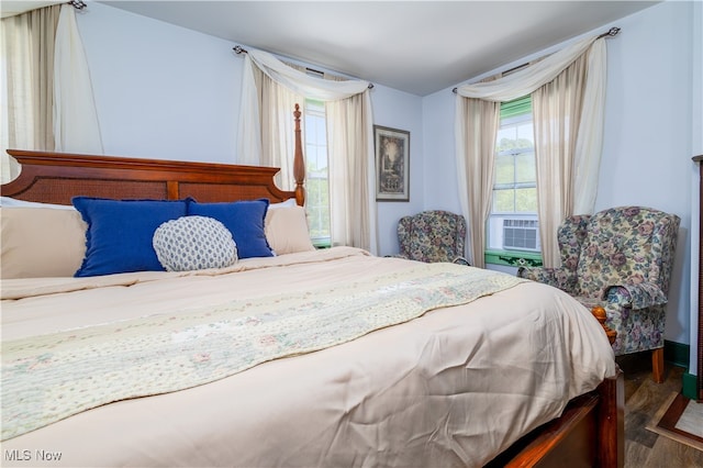 bedroom with hardwood / wood-style floors and cooling unit