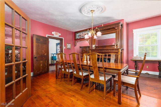 dining area featuring a notable chandelier and hardwood / wood-style flooring