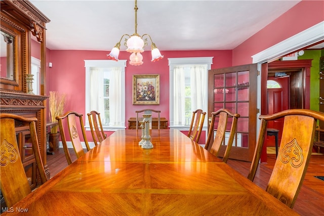 dining space featuring a notable chandelier, hardwood / wood-style flooring, and a wealth of natural light