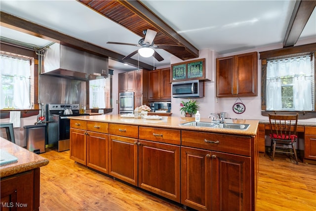 kitchen with light hardwood / wood-style flooring, ceiling fan, appliances with stainless steel finishes, wall chimney range hood, and a wealth of natural light