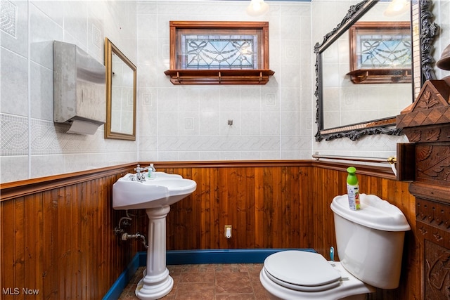 bathroom featuring toilet and tile patterned flooring